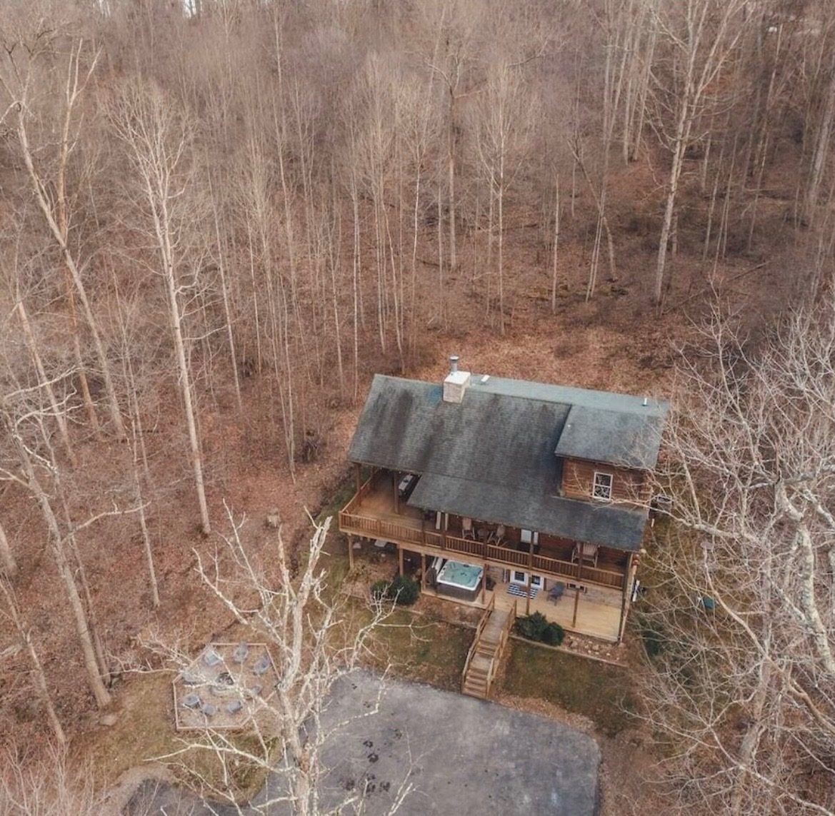 Aerial view of the lodge surrounded by winter woods