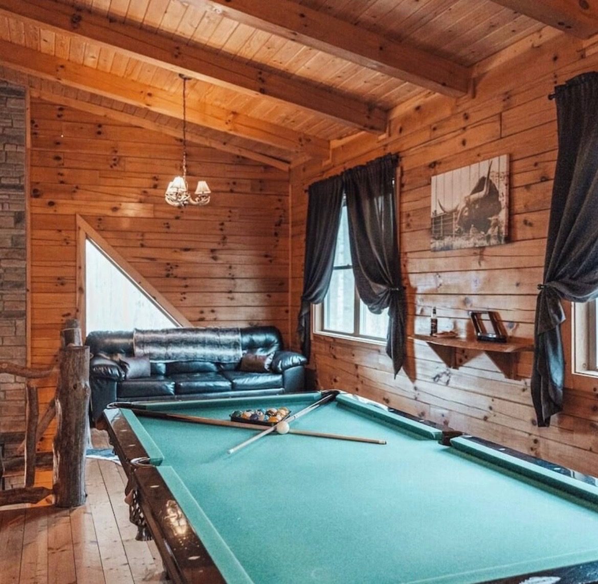 Pool table in the loft game area with a leather sofa